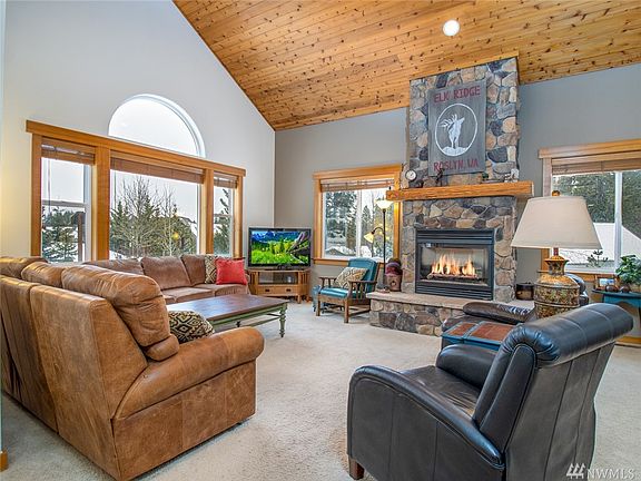 Spacious great room with vaulted ceilings and floor to ceiling rock fireplace!
