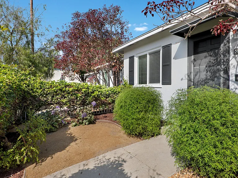Plant-filled private front yard.