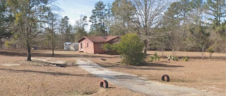 Outside view of entire home with land area.