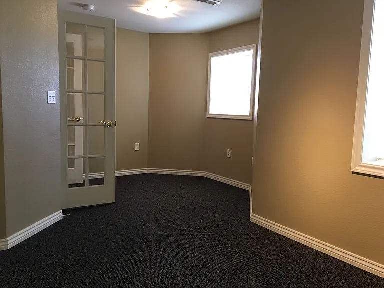Inside the south bedroom looking back at the french doors.
