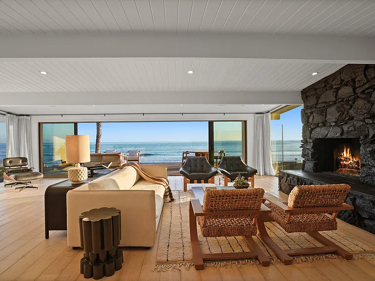 Unwind by the fire, framed by rich textures and uninterrupted views.