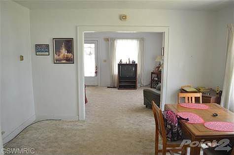 View of dining room with living room beyond. Dining room is large enough for both dining space and h
