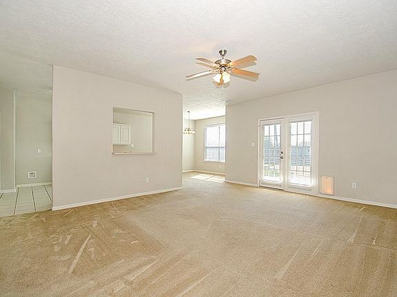 Living room has double doors leading to backyard.