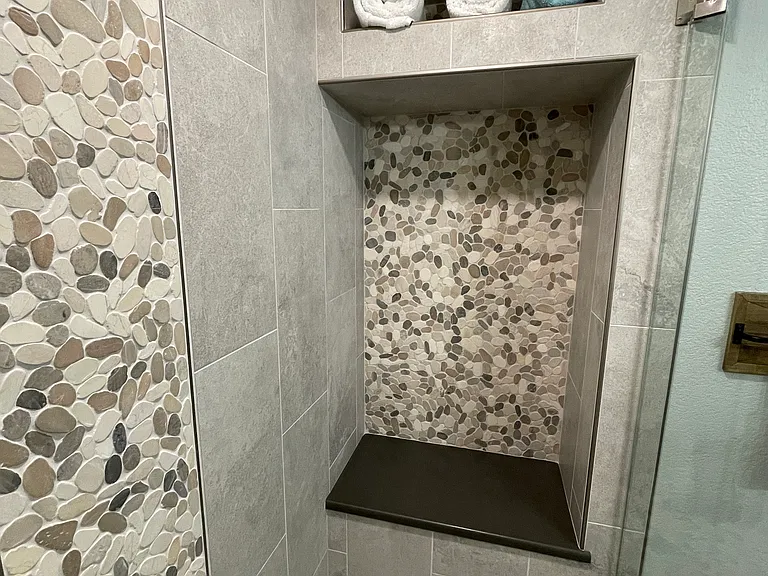 Shower niche for sitting and a towel niche above.
