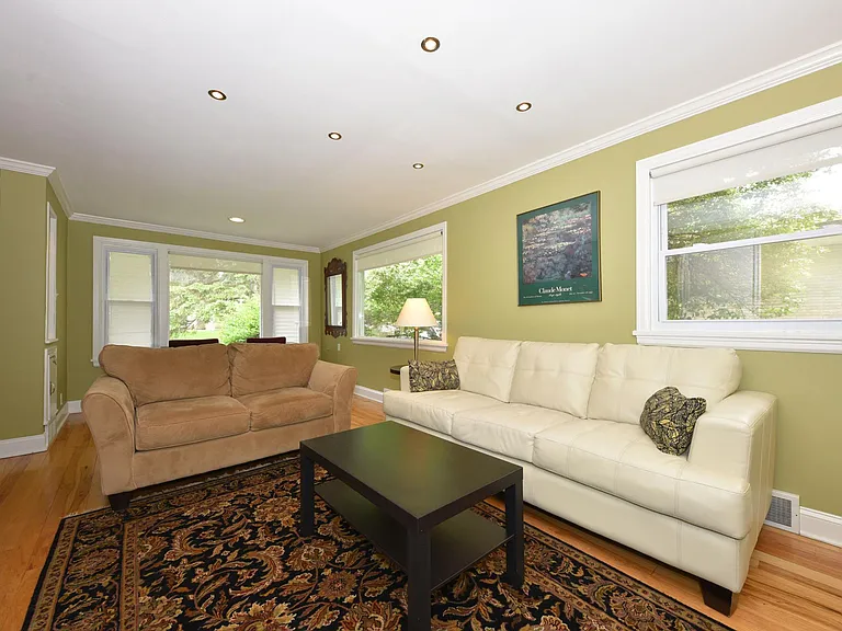Great Room with Hardwood Floors and Window Treatments. Room behind the loveseat for a dining table or desk.