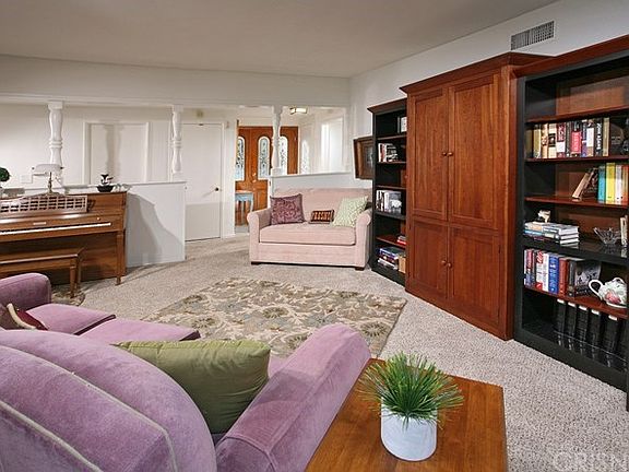 The spacious living room is bathed in natural ligh