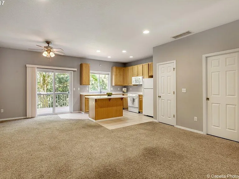 Open Floor Concept flows beautifully in the lower level of the townhome overlooking the green space at the back .