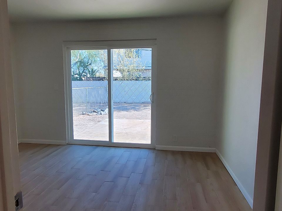 Bright Bedroom with sliding patio doors to large fenced backyard.