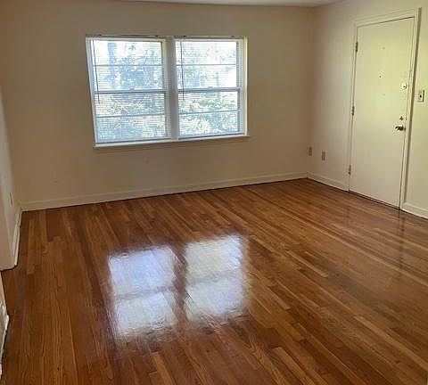 Spacious living room measures 13' by 16' with beautiful hardwood floor freshly refinished