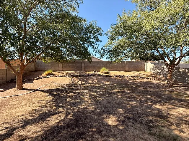 Backyard. Sprinkler system/timers will bring this private patio and backyard lush green. Great shade trees.