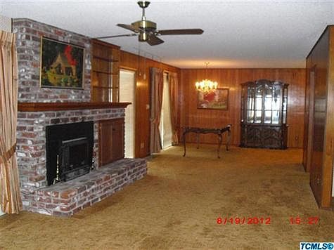 Large Masonry fireplace, with wood stove insert, separates the Living Room and Dining Room.