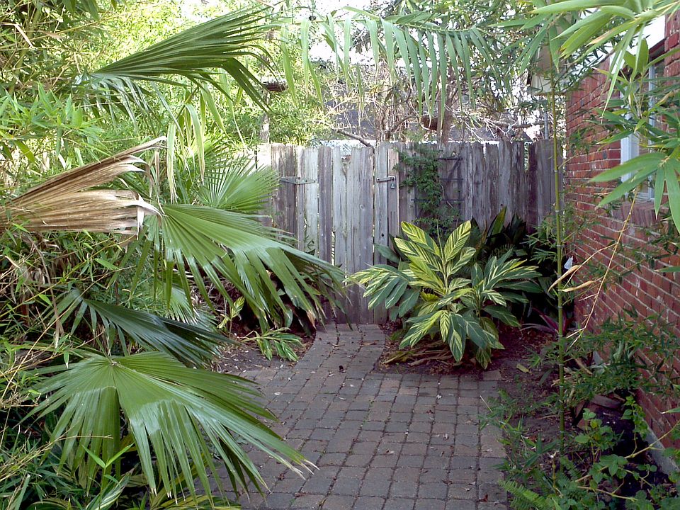 Brick side courtyard creates lovely private sitting area. 
