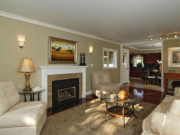 Open floorplan, gleaming hardwood floors, classic fireplace surround
