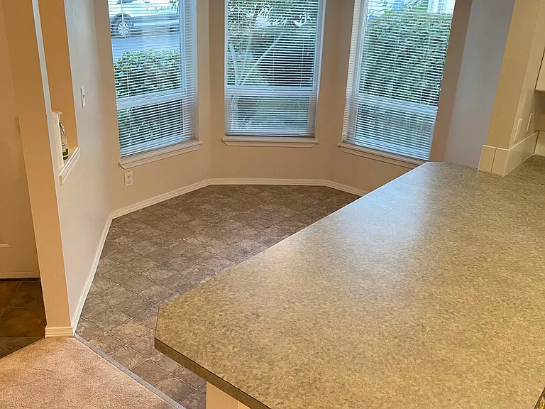 Breakfast nook with bar adjacent to kitchen
