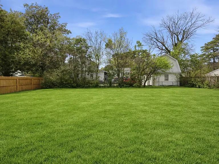 The huge backyard includes a deck and grill. Perfect for kids or pets that want to run around.