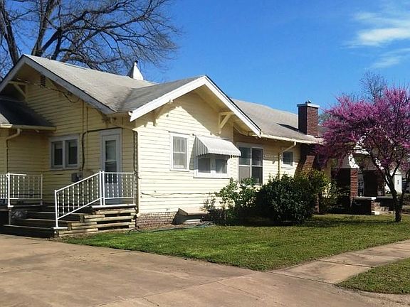 Side View with Back Porch and Redbud Trees.