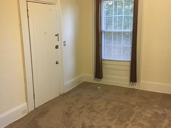 Living room with ceiling fan. New carpeting