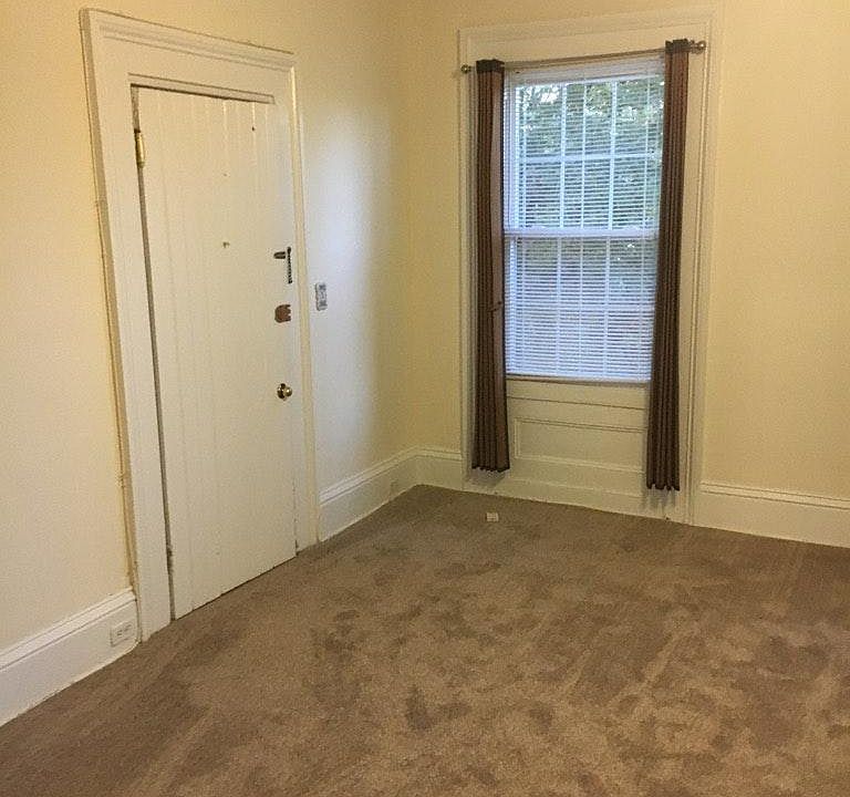Living room with ceiling fan. New carpeting