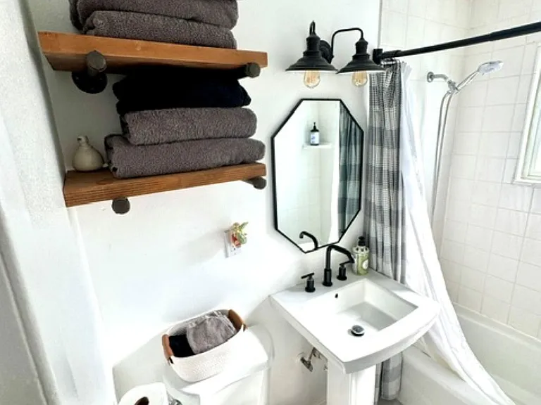 1 big enough bathroom with open shelving and nice natural light with the window