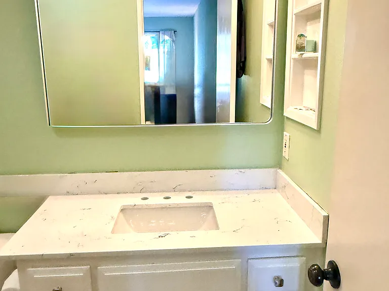 Master bath with new counter, lighting and mirror.