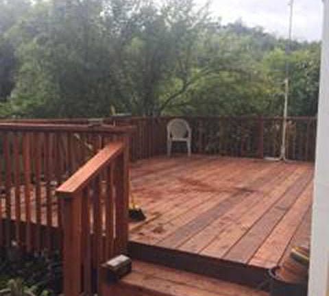 New deck leads to yard, two steps.