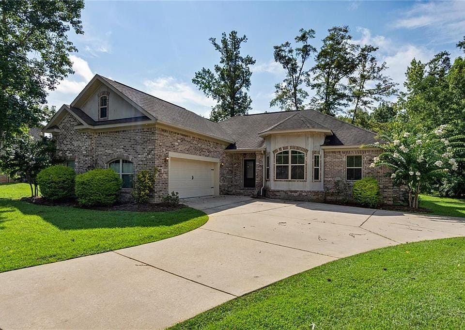 View of front of house with a front lawn and a garage