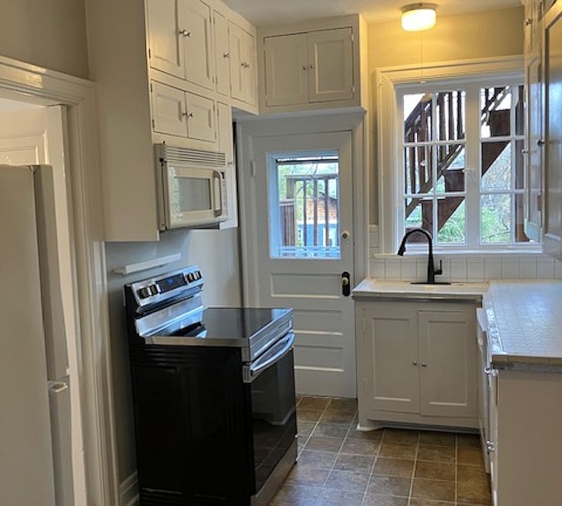 Kitchen with door to rear steps and carport
