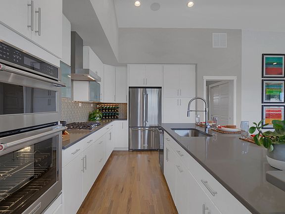 Kitchen features stainless appliances, Quartz slab, Maple cabinetry, hardwood and more