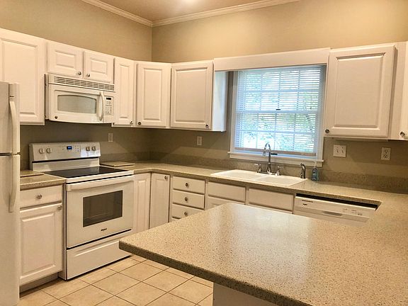 Eat in kitchen with brand new countertops, new stove, and dishwasher.