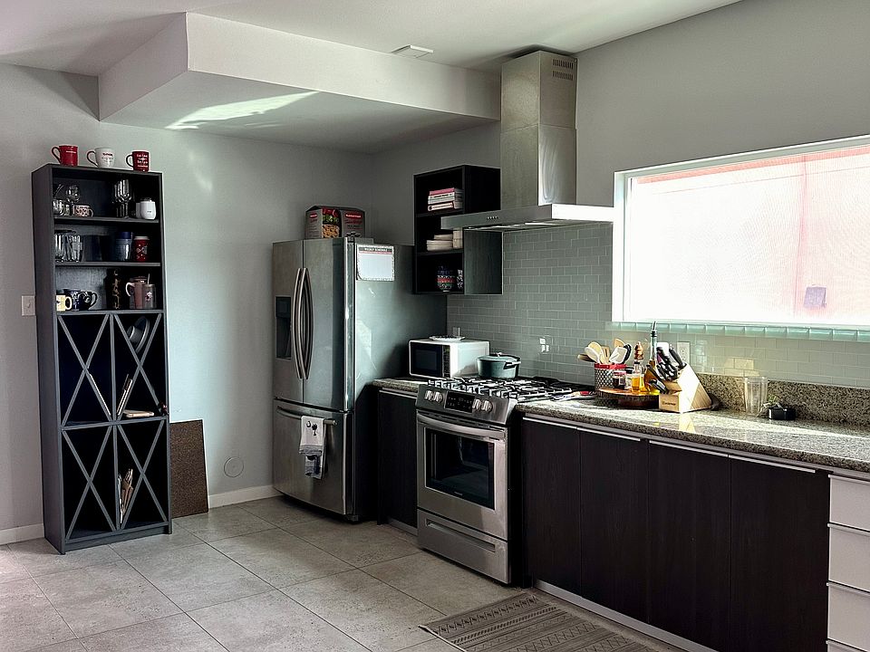 Stainless Steel kitchen with refrigerator and gas stove