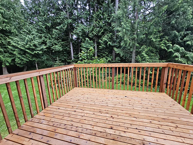 Newer Deck off of Dining area overlooks private backyard with firepit and plenty of room to play!