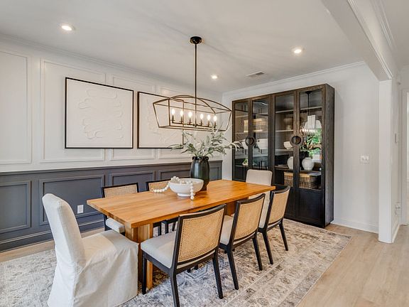 With its inviting ambiance and tasteful decor, the dining room area exudes warmth and hospitality.