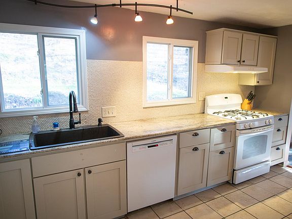 Kitchen with granite counters, penny tile backsplash