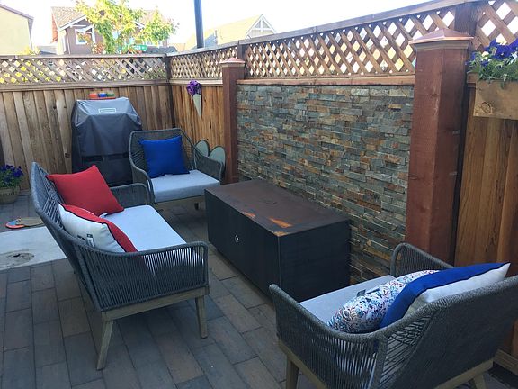 Side Yard with outdoor fireplace and bbq hooked up to natural gas. (Patio furniture not included.)