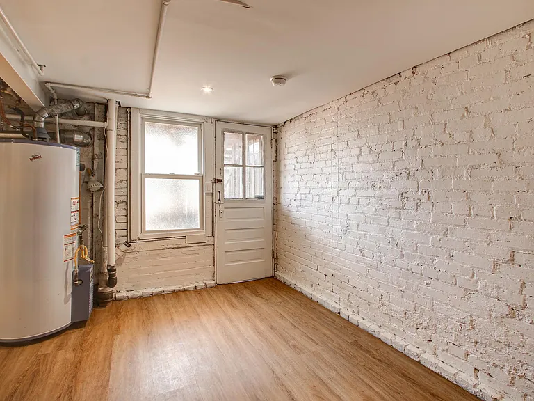 Basement with door leading to backyard