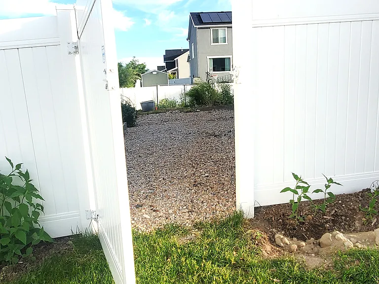 Fenced access to the private entry. This side path connects the front of the property directly to your entrance.