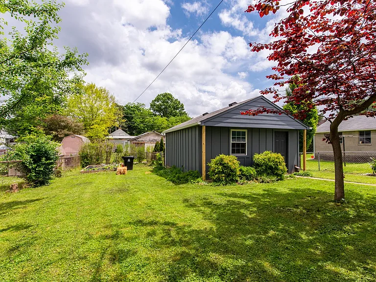 Fully-fenced backyard with view of the garage