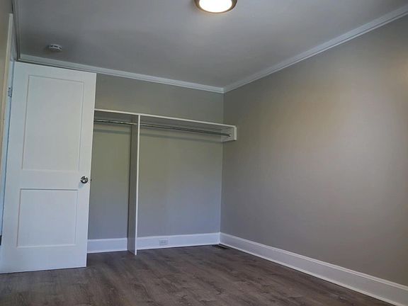 Bedroom with built in closet against wall