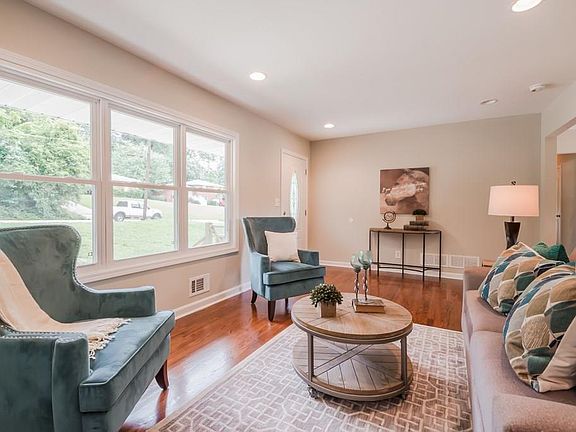 Sunny and spacious living room leads into open dining room and kitchen area. Hardwood original and beautifully refinished. Windows are double hung and energy efficient.