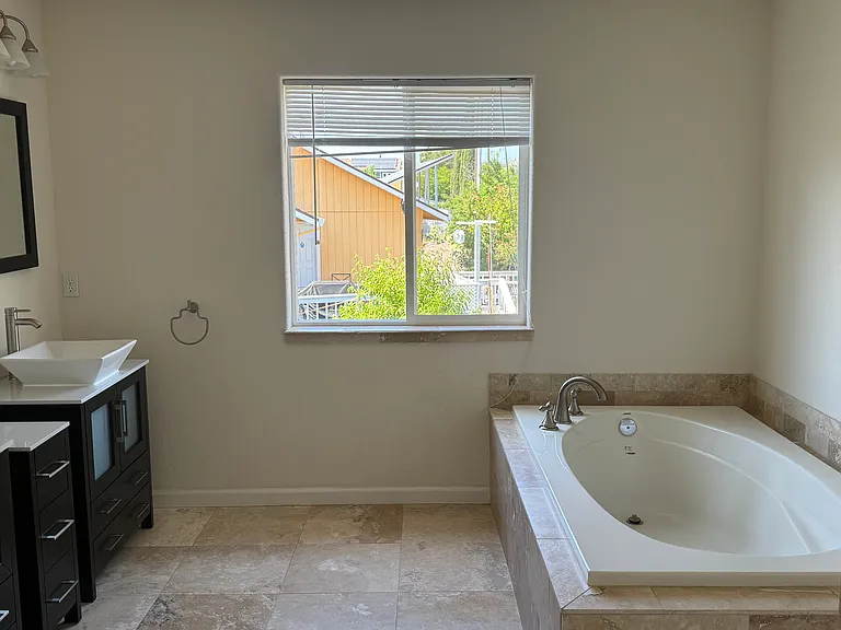 Master bath with double vanity and soaking garden tub