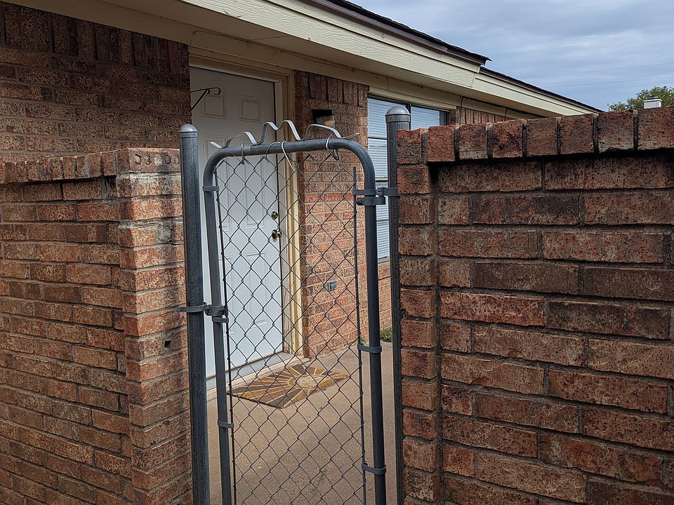 Front door is beyond the gate.