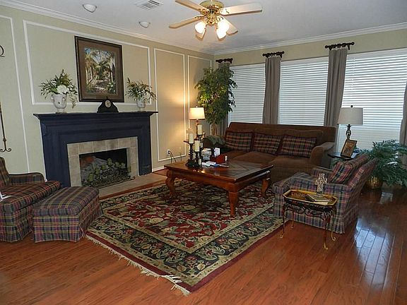 Grand second living room with a wall of windows over looking the huge backyard. Open Concept for keeping track of all the fun family activities.  The powder room with pedestal sink is close by for easy access.