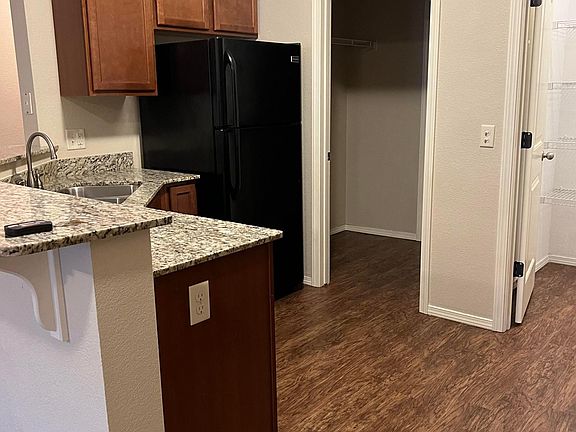 Kitchen has granite countertops, stainless-steel sink and walk in pantry. Frigidaire appliances include refrigerator with ice maker, electric range, dishwasher and microwave.