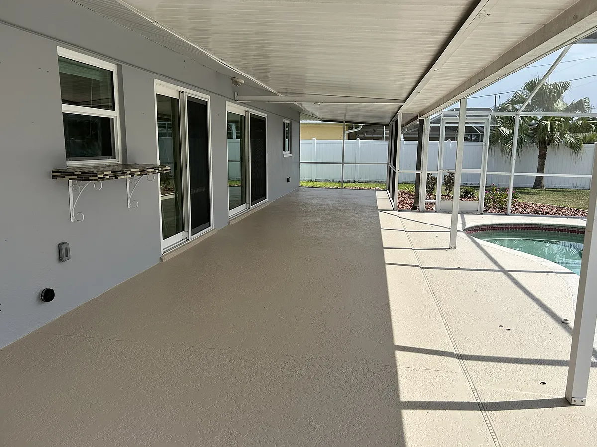 Covered lanai with pass through window to kitchen - 2210 SE 8th Pl