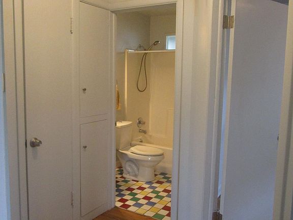 Hallway with linen storage and coat closets.