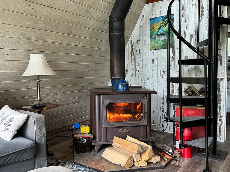Beautiful Fireplace and the spiral staircase up to the loft