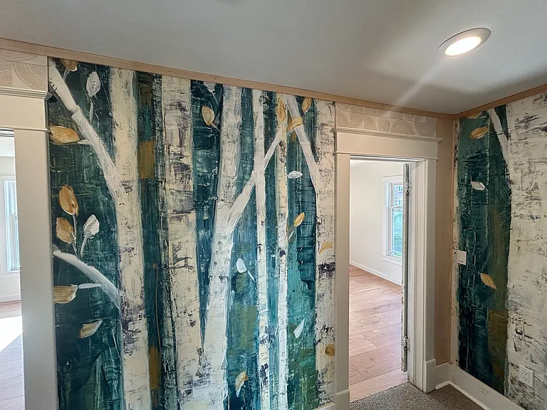 Upstairs hallway with Swedish birch tree mural. Hall and stairs are carpeted but still covered in protective plastic.