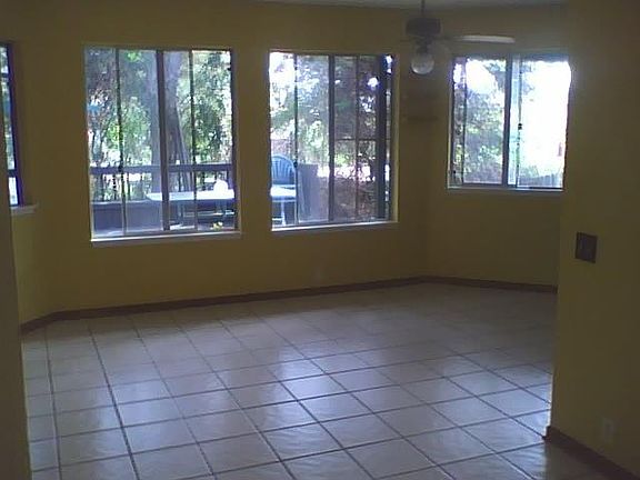 This is the living/kitchen area - living space is to the left, kitchen is around the corner to the right. All windows face the patio/deck and there is a slider door to the left that goes out to the patio.