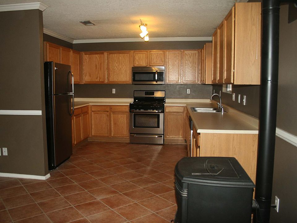 Kitchen with stainless steel appliances and wood pellet stov