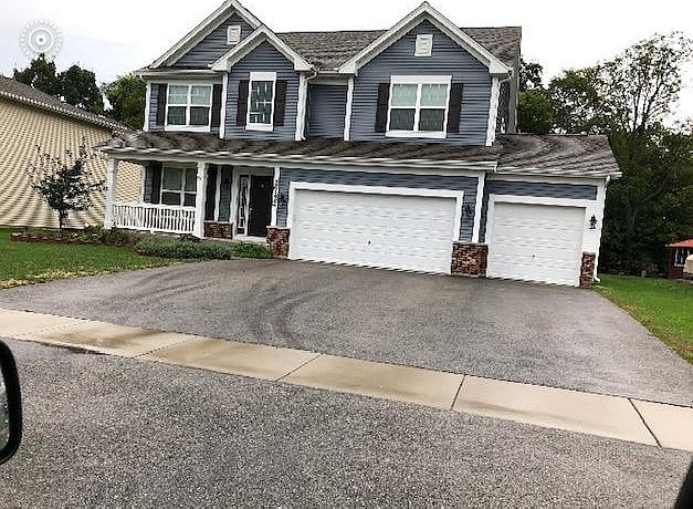 Beautiful landscaped front with three car garage.